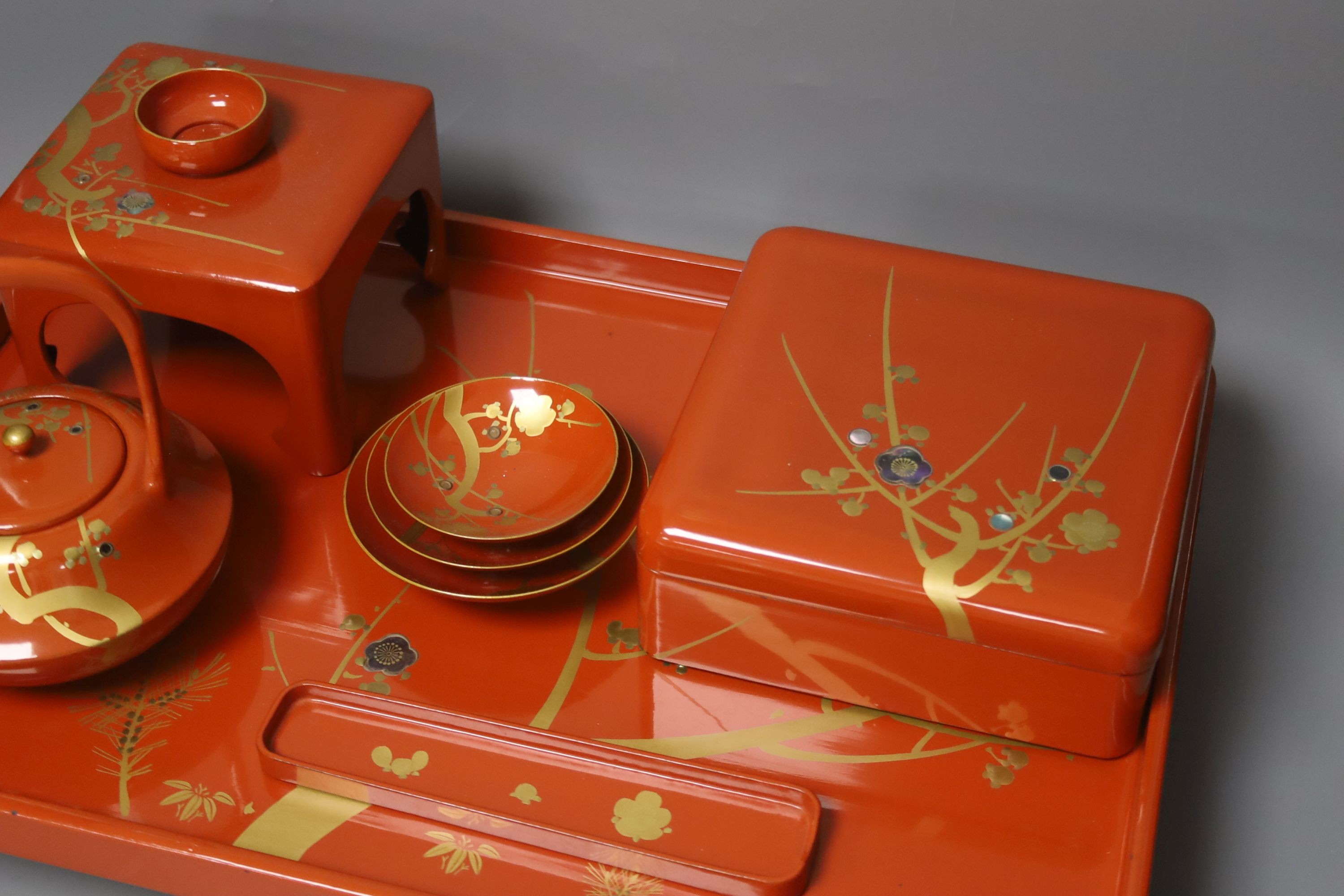 A Japanese red lacquer ceremonial sake set